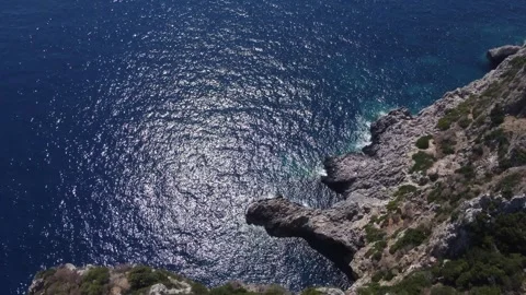Drone flight over cliff and deep blue sea Stock Footage 313633634