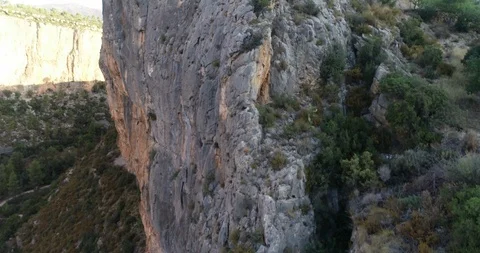 Drone flight over cliff cliff towards mountain house Stock Footage 124221806