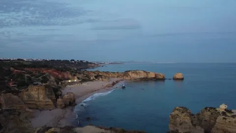 Drone flight over cliffs and beach in the algarve during blue hour Stock Footage 314451768