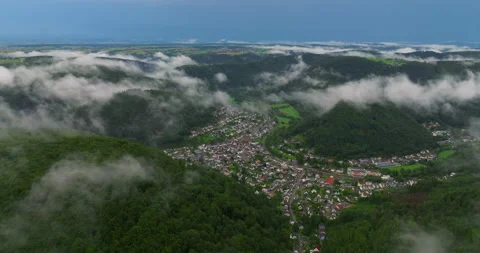 Drone flight over clouds and green fresh forest in hilly Europe, Germany. Aerial Stock-Footage 251637864