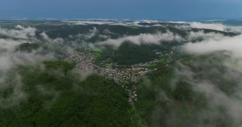 Drone flight over clouds and green fresh forest in hilly Europe, Germany. Aerial Stock Footage 252944345