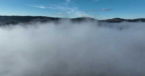 Drone flight over the clouds during sunrise. Fly through the clouds. Fresh Stock Footage 228715612