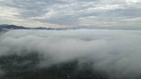 Drone flight over the clouds towards the mountains Stockbeeldmateriaal 137945202