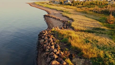 Drone Flight Over The Coastline Of The Atlantic Ocean Sandy With Rocks &amp; Grass Stock Footage 255350192