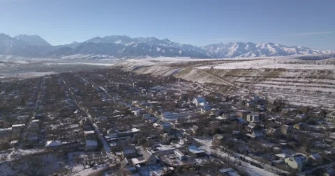 Drone flight over a cold village covered with snow in winter. DJI 0877 Stock Footage 226186397