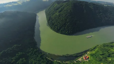 Drone Flight over Danube River and Donauleiten Forest with Cargo Ship Stock Footage 345011833