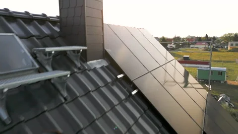 Drone flight over a dark tiled gable roof with solar panels. Stock Footage 242700069