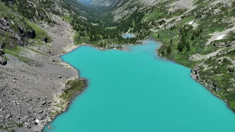 Drone flight over an emerald lake; location: Altai. Stock Footage 345037243