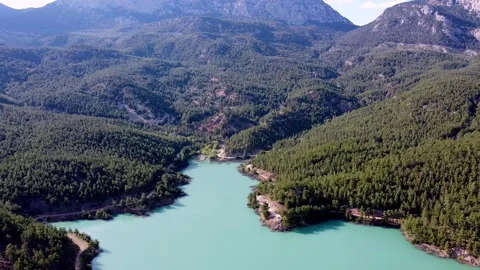 Drone flight over an emerald mountain lake Stock Footage