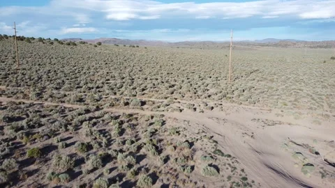 Drone flight over empty desert hills with only power lines. Stock Footage 200289139