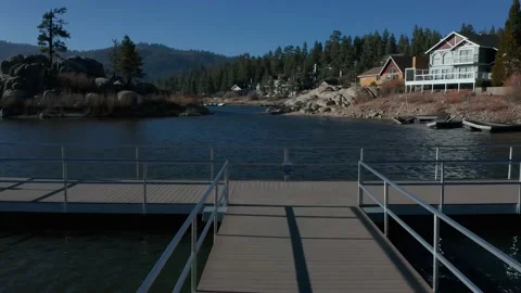 Drone flight over end of dock revealing lake beyond 4K Stock Footage 150200050
