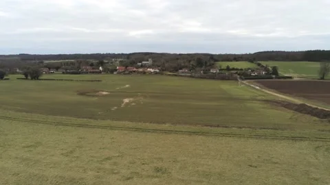 Drone flight over fields towards village Stock Footage 205267224