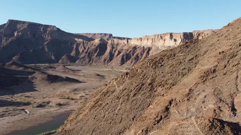 Drone Flight Over Fish River Canyon Trail and Rugged Mountains in Namibia 4K Stock Footage 337440857