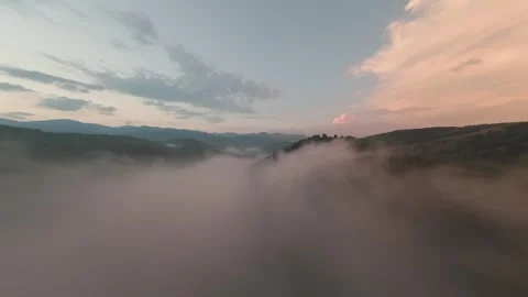 Drone flight over fog-filled mountain valley at sunset near Belitsa, Bulgaria. Stock Footage 343685767