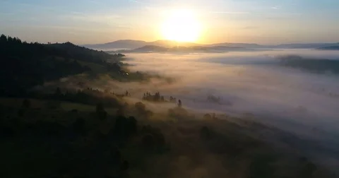 Drone flight over foggy mountain village during sunrise. 스톡 동영상 80670475