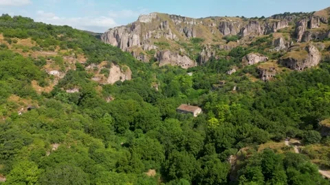 Drone Flight Over Forest Toward Cave Cliffs in Southern Armenia Stock Footage 344470517