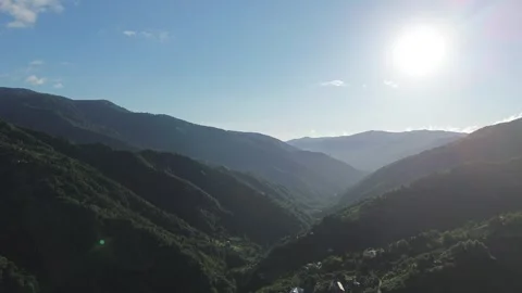 Drone Flight Over Forested Mountains, Sun Disappearing Behind Ridge at Golden Ho Stock Footage 341369210