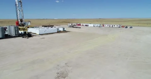 Drone flight over a fracking pad focusing on a semi truck and working Stock Footage 167931350