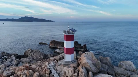 Drone flight over Ganh Den Lighthouse toward the sea, Phu Yen, Vietnam Vidéo 339407089