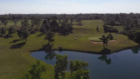 Drone flight over golf course with pond, 4k Stock Footage 135950573