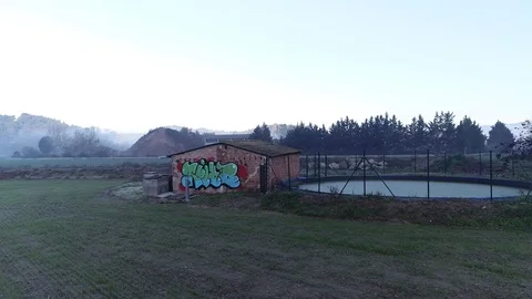 Drone flight over graffiti in an old rural cottage Stock Footage 99203692