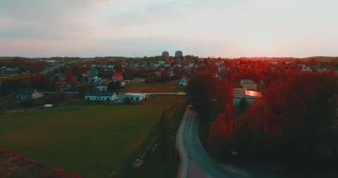Drone flight over grass, nature at sunset. Top view of the small town, trees  Stock Footage 189855602