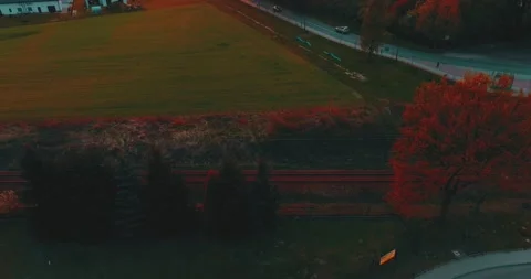 Drone flight over grass, nature at sunset. Top view of the small town, trees  Stock Footage 189855785