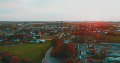 Drone flight over grass, nature at sunset. Top view of the small town, trees  Video stock 189859161