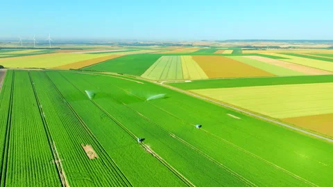 Drone flight over green fields with irrigation sprinklers 動画素材 315503225