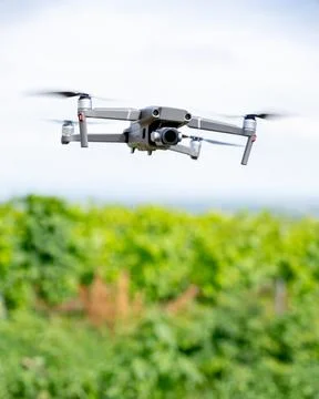 Drone in Flight over Green Fields: Aerial Technology &amp; Landscape Stock Photos