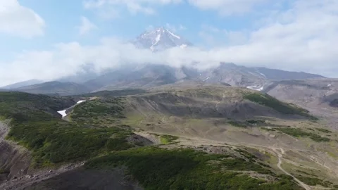 Drone flight over green hills with Koryaksky volcano in Kamchatka Stock Footage 311949974