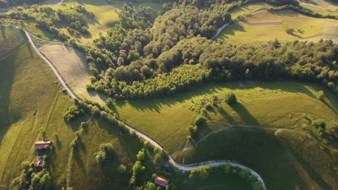 Drone flight over green hills in Romania at sunset Stock Footage 314851588