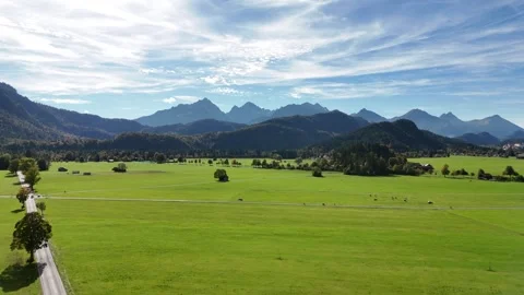 Drone flight over green valley towards the Bavarian Alps on a sunny day Stock Footage 319789682