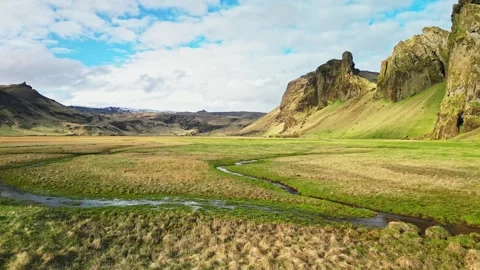 Drone flight over green valley and winding stream Iceland 4K Stock-Footage 344111816