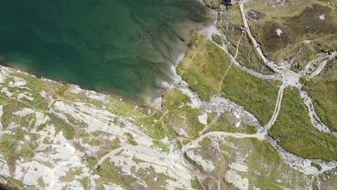 Drone flight  over Grimselpass, Switzerland at 2168 meters.  Wit Lakes and Al Stock Footage 138726392