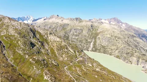 Drone flight  over Grimselpass, Switzerland at 2168 meters.  Wit Lakes and Al Stock Footage 138726438