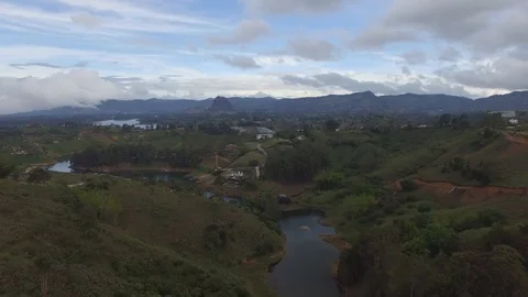 Drone flight over Guatape reservoir, with the "El Peñol" rock at background. Stock Footage