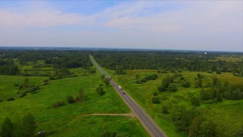 Drone flight over the highway among the green forests Stock Footage