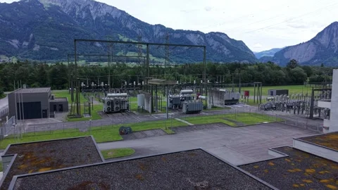 Drone Flight Over Hydroelectric Power Plant and Cooling Systems in Alpine Valley Stock Footage 336367196