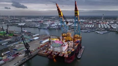 Drone flight over industrial area with cargo ports and a heavy lifting crane Stock Footage 313033624