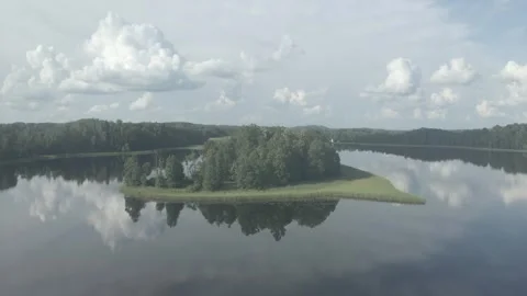 A drone flight over an island in a lake Stock Footage 335998520