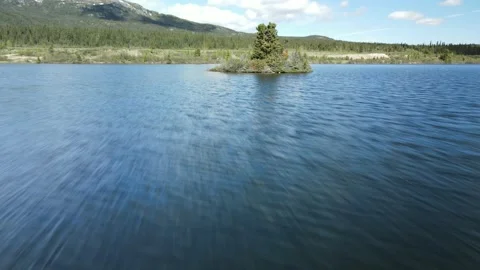 Drone flight over Lake and little Island, Sunny Day Stock Footage 169554177