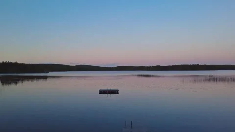 Drone flight over a lake in Sweden, taking off from a wooden jetty. Scandinav Stock Footage 345658929