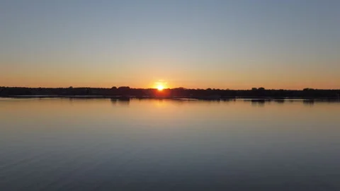 Drone Flight Over Lake Toward Shoreline and Sunset Stock Footage 317359305