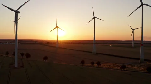 Drone flight over a large field with many wind turbines turning. On the horizon, Stock Footage 163099384