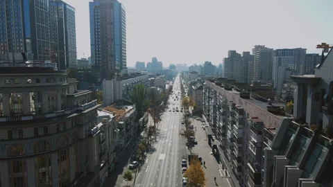 Drone flight over long city avenue with car traffic in Kyiv Ukraine Stock Footage 346500930