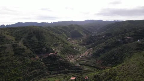 Drone Flight Over a Lush Green Village Nestled Between Two Mountains Stock Footage 315099745