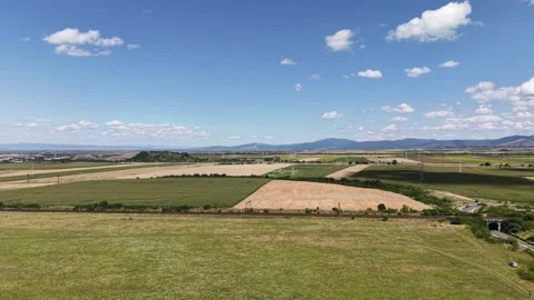 Drone flight over lush green grass towards railway tracks Video stock 345432276