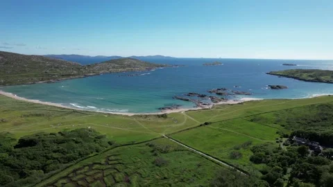 Drone flight over meadows to a sandy beach at Derrynane, Kerry, Ireland Stock Footage 346745864