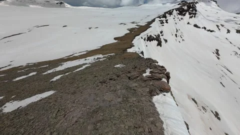 Drone flight over melting spring snow on Mount Aragats, Armenia Stock Footage 343876385